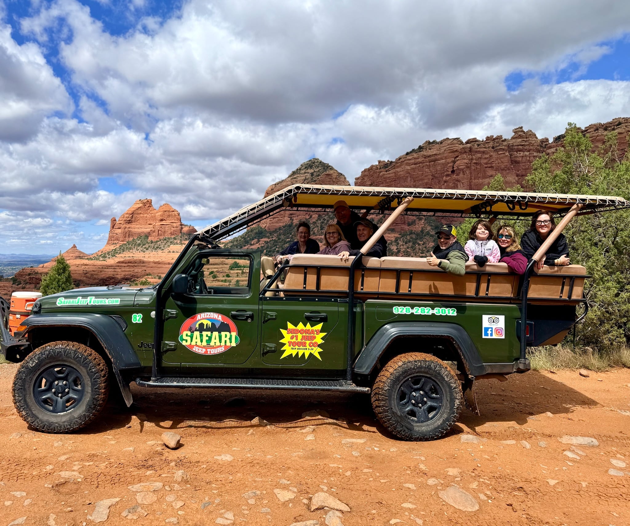 Happy riders inside safari jeep on guided Sedona adventure