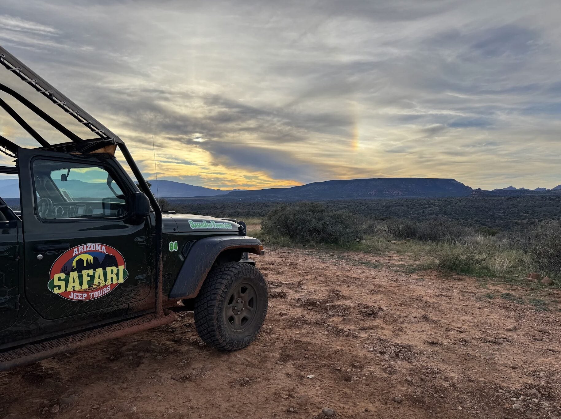 A photo of a parked Safari Jeep Tour vehicle overlooking Sedona's red rock views