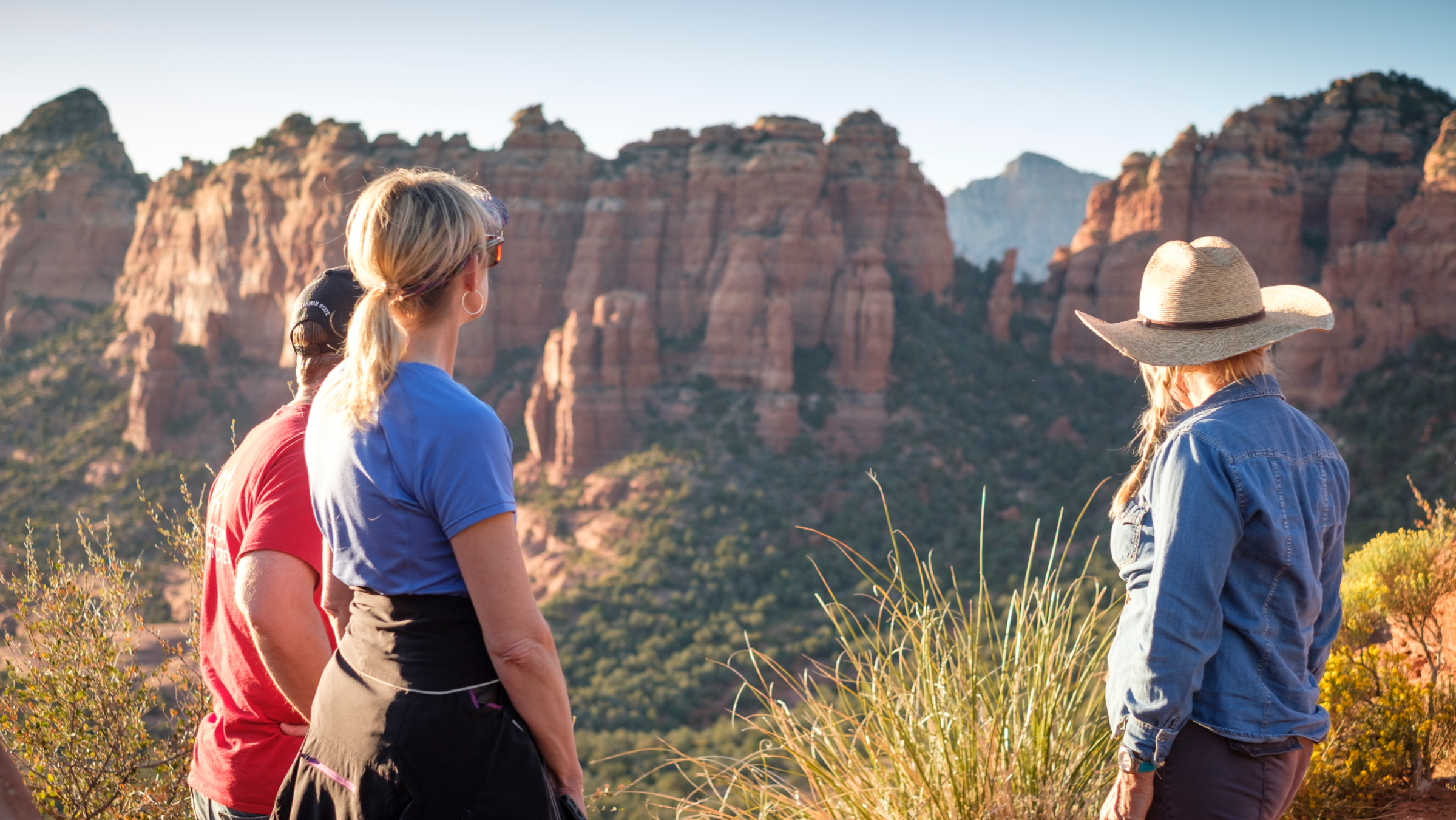 people looking at red rocks