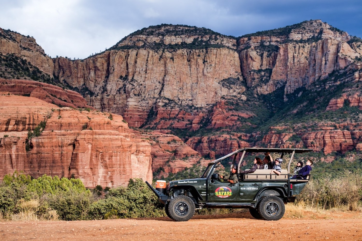 a truck is parked in front of a canyon