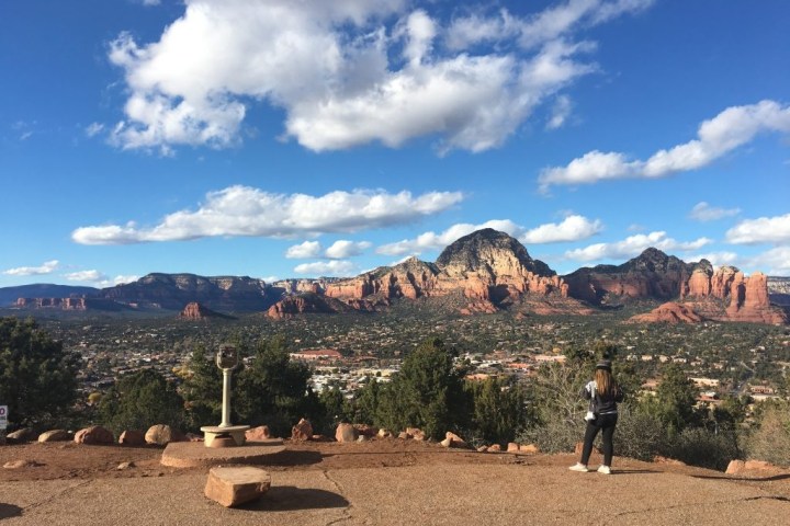 a group of people standing in front of a mountain